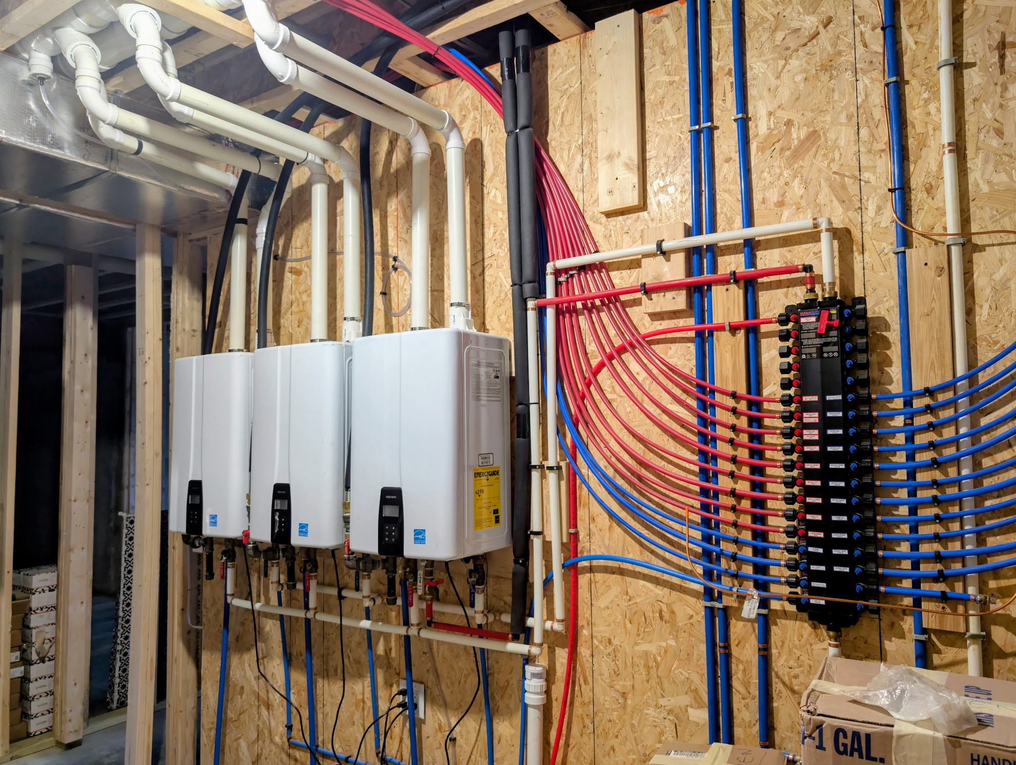 Three water heaters and organized PEX manifold installed by Z Tech Mechanical